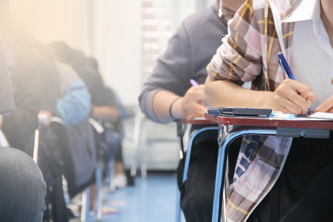 Students in a classroom writing at their desks