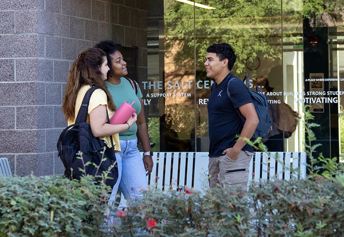 3 students chatting outside the SALT Center