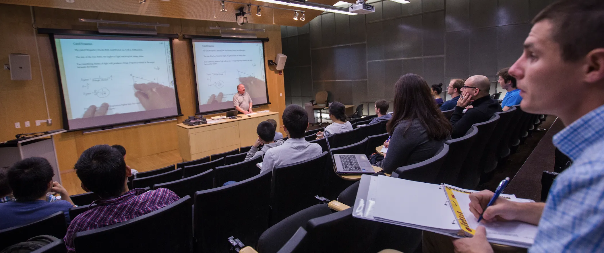 Student in class taking notes