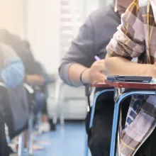 Students in a classroom writing at their desks